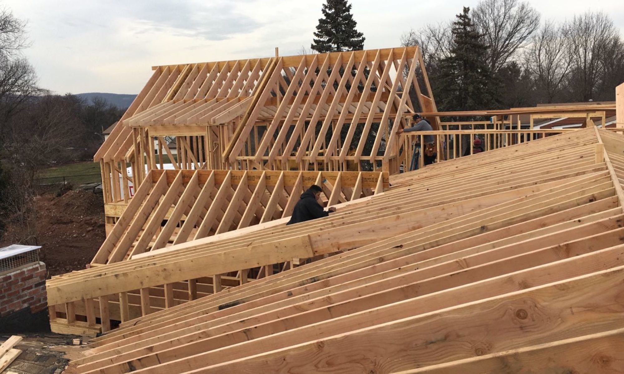 Men Working on Roof Framing for House Addition